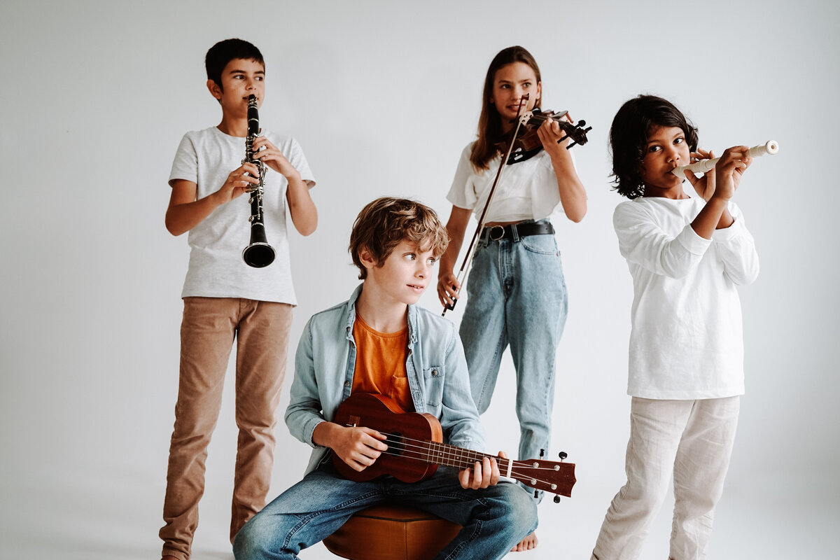Four Munster Music Academy students with clarinet, violin, recorder and ukulele